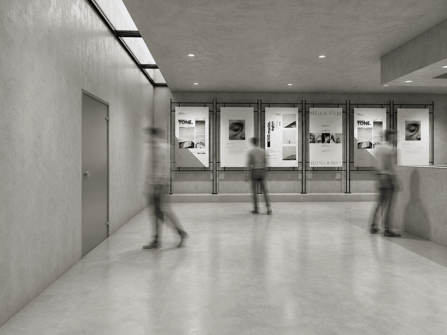 Gallery corridor: a row of printed posters mounted on glass racks beneath a skylight strip, visitors passing through.