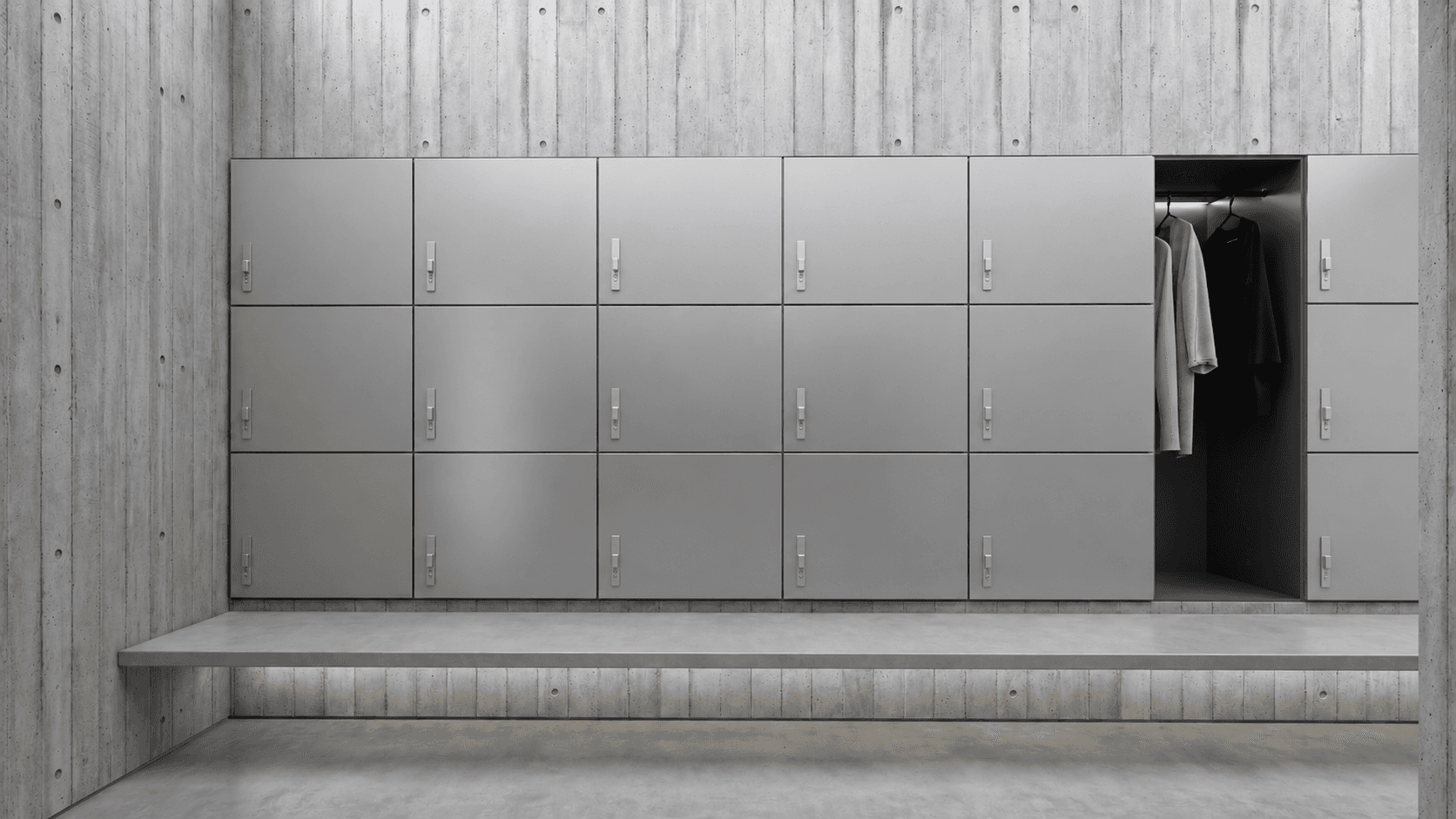 Locker wall: brushed steel doors above a floating concrete bench, one compartment open to hung robes.