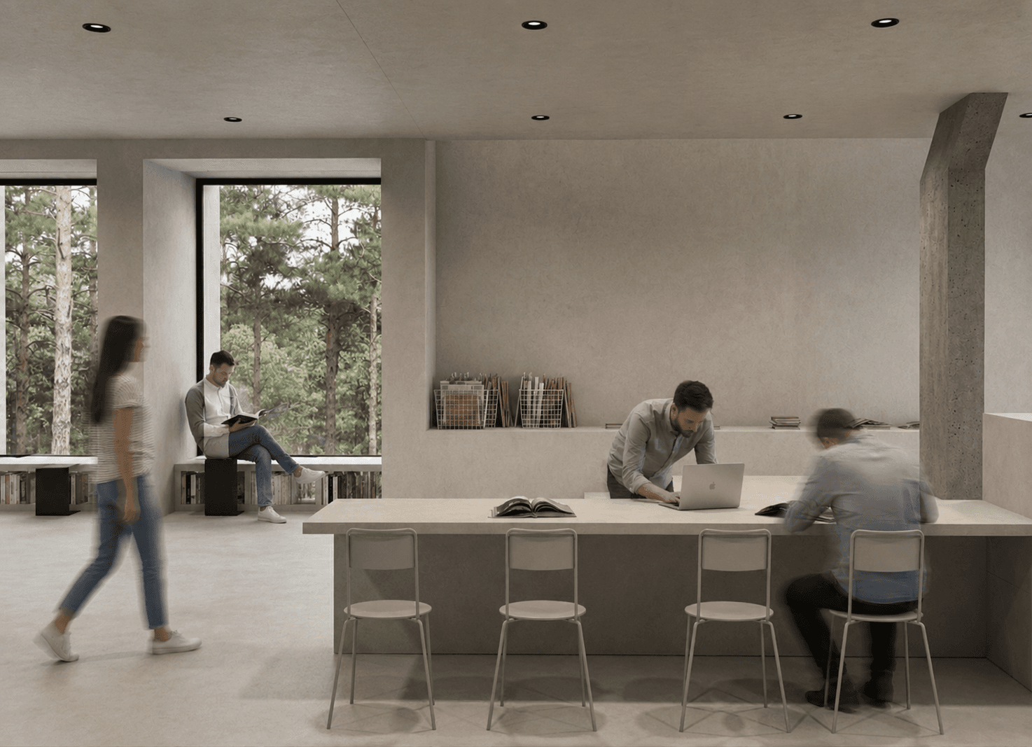 A shared work table beside a concrete column, visitors reading and working before the pine forest windows.