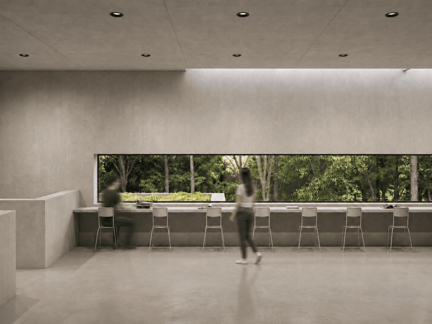 Leaving MASS: the reading pavilion's long window counter, forest glowing through the ribbon glazing beyond.