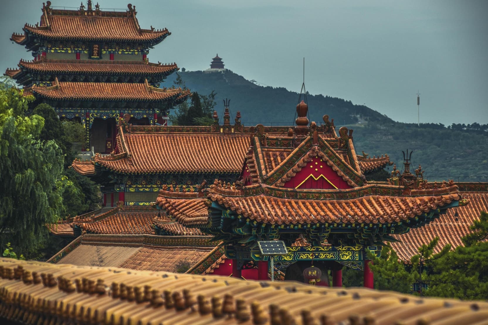 Stacked pavilion roofs with deep timber eaves.