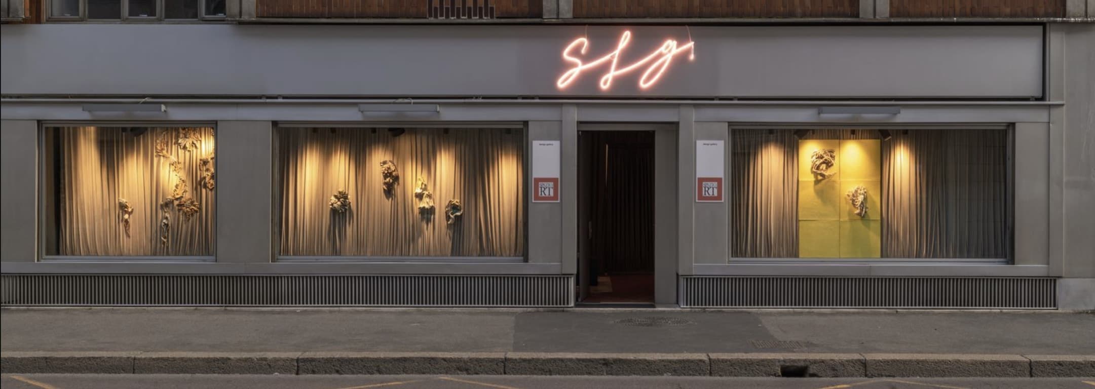 The Brera storefront on its Milanese street at night, display windows either side of the door.