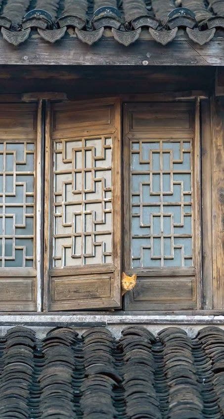 A carved timber lattice door panel.
