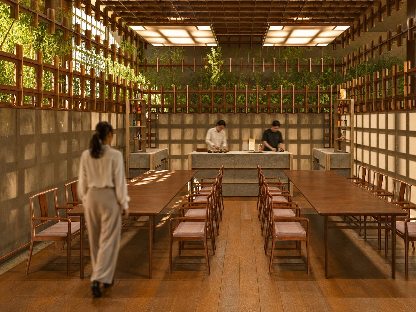 The workshop: a long working table under a lit ceiling grid, lattice walls and planting behind.